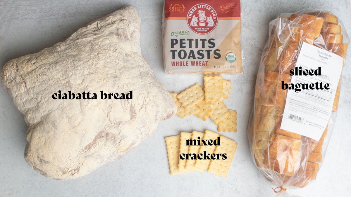 Assorted breads on a white board.