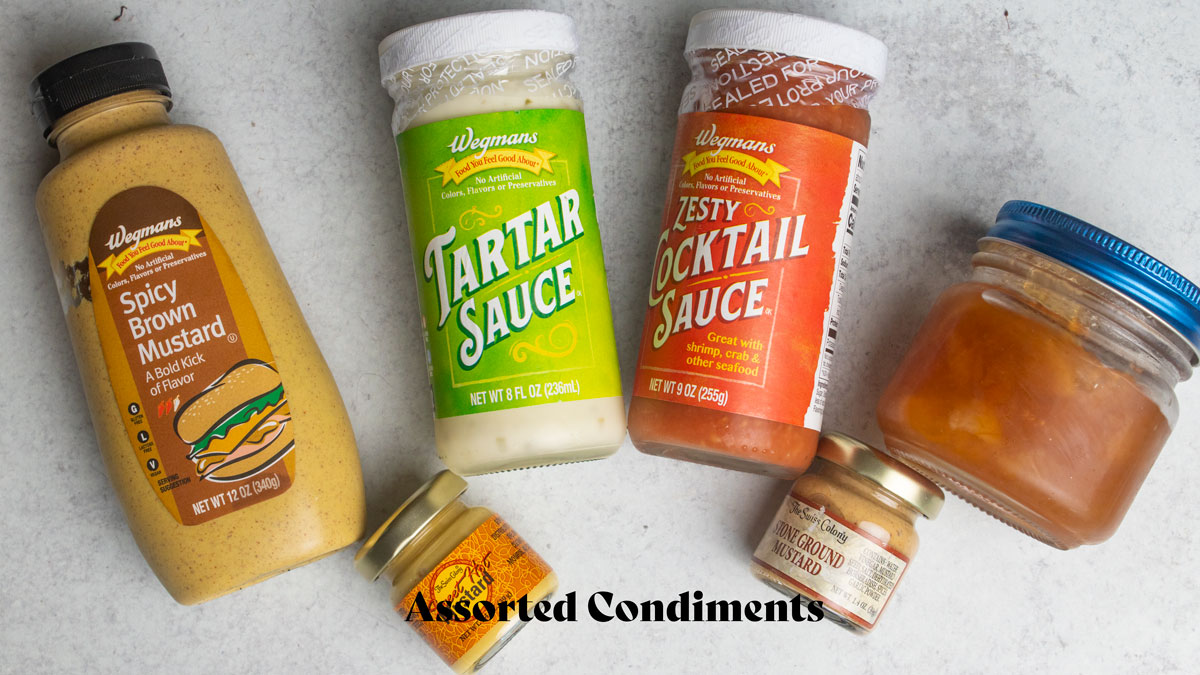 Different condiments displayed on a white board.