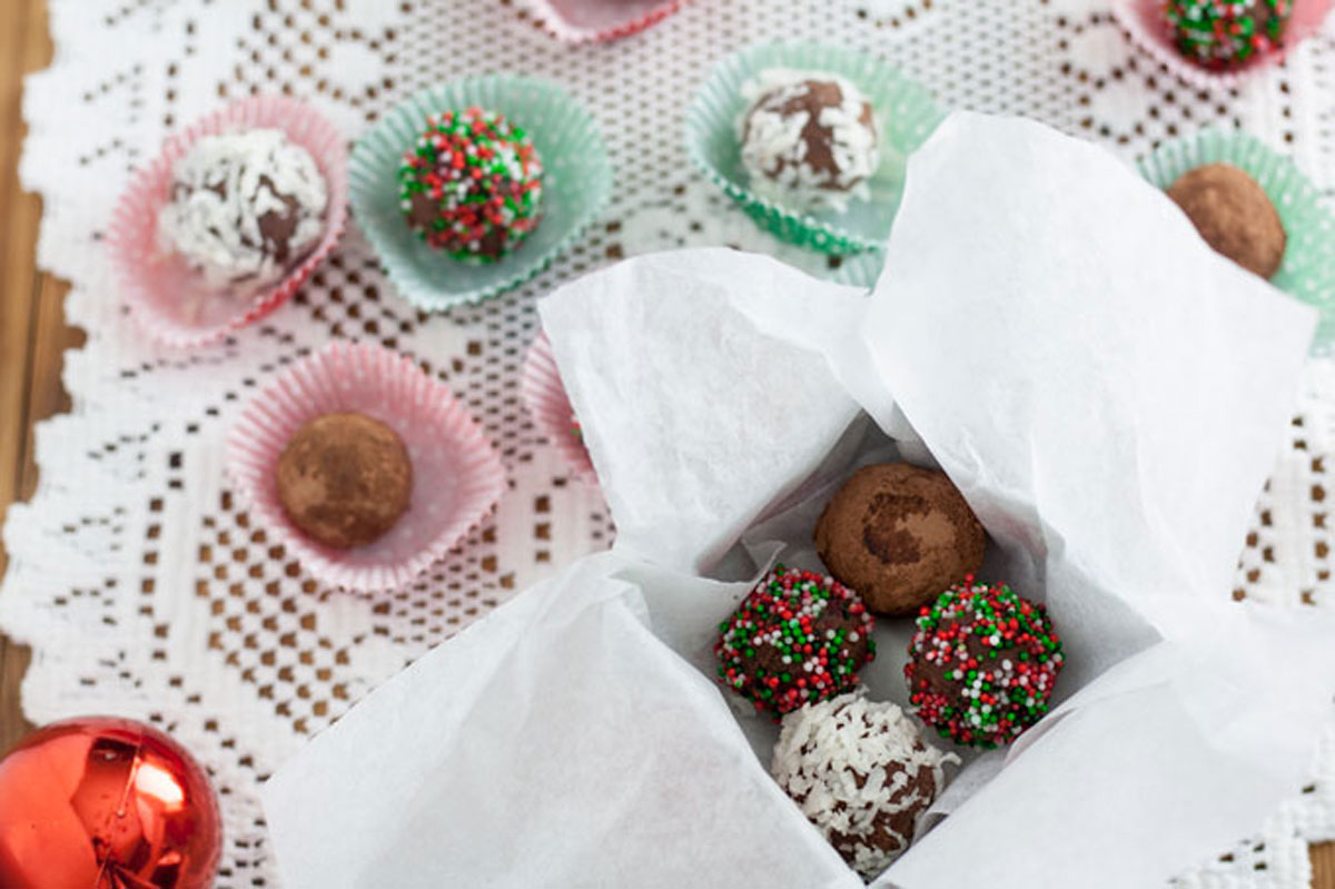 Sprinkles, coconut and cocoa covered truffles in gift box.
