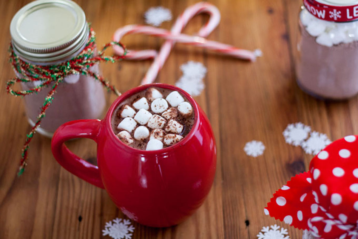 Red mug filled with cocoa and mini marshmallows.