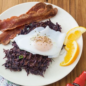 sweet potato waffles with egg on top and bacon