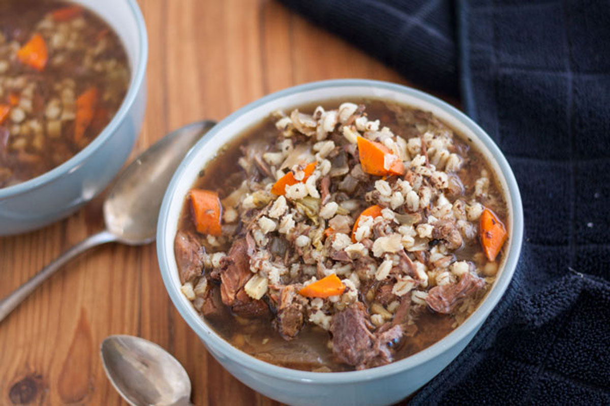 Two bowls of venison soup in grey bowls