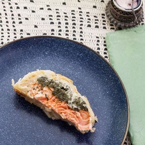 slice of salmon wellington on blue plate