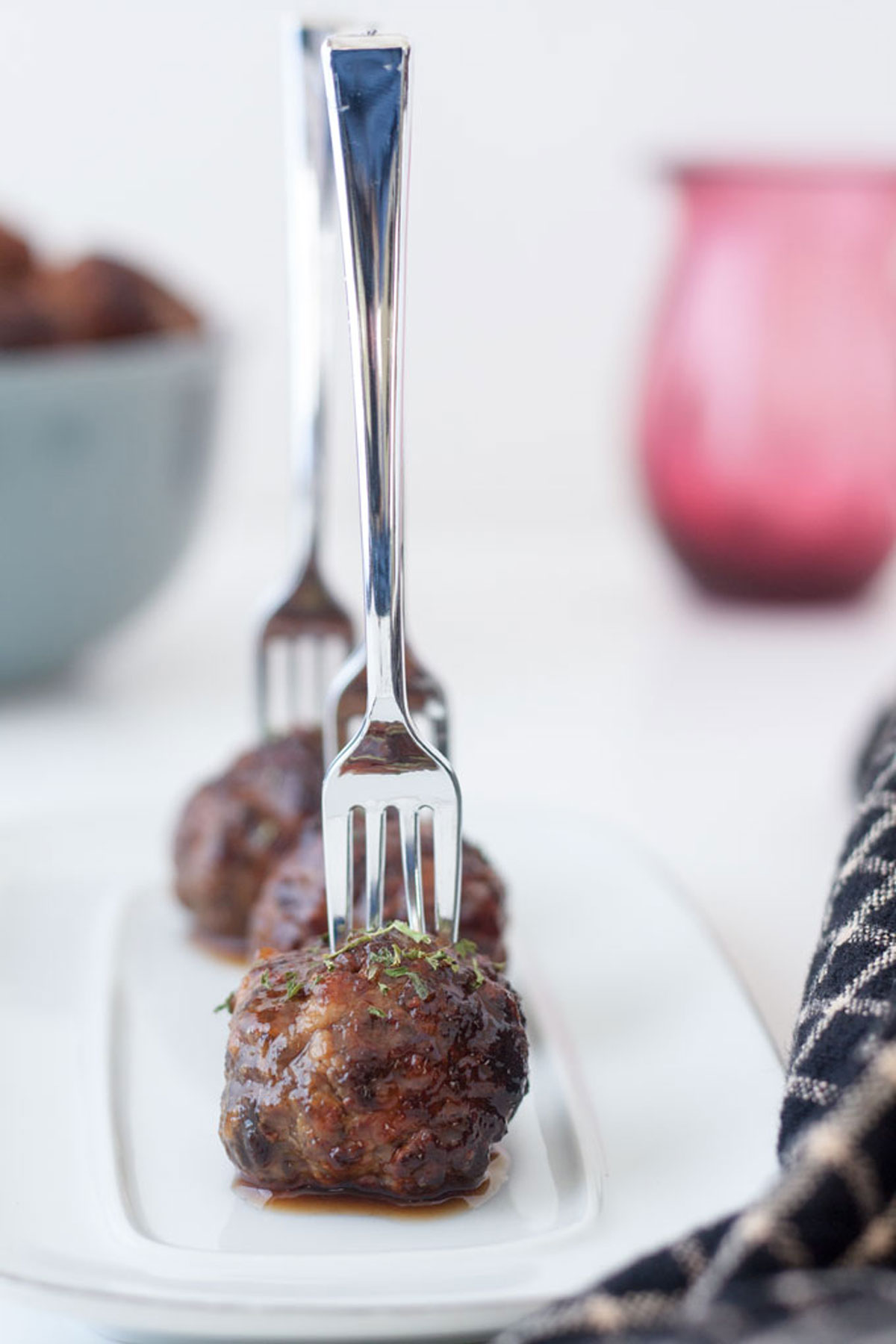 Air fryer meatballs on white tray with mini forks stuck in them