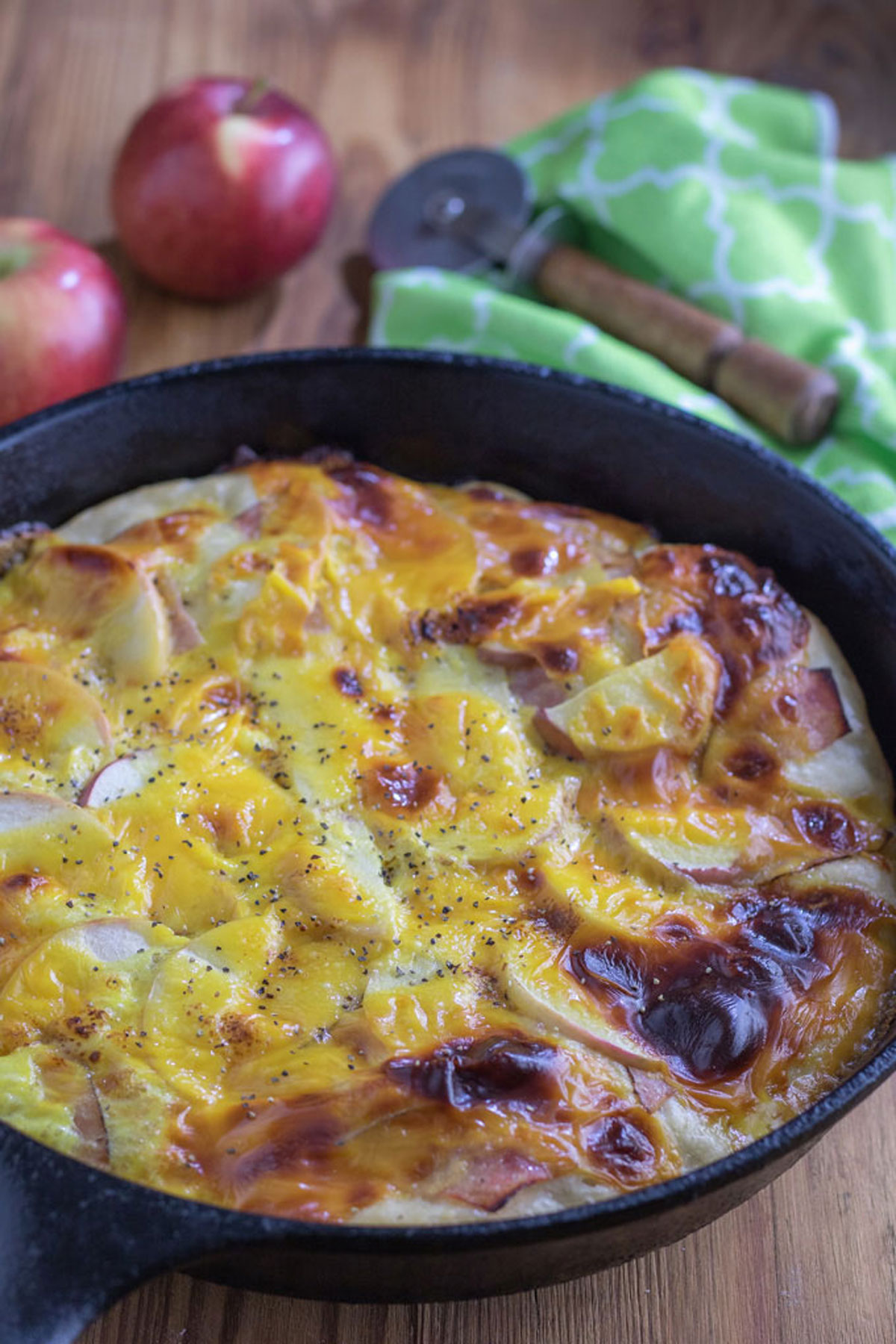 Breakfast Pizza with Ham & Apple in black cast iron pan.