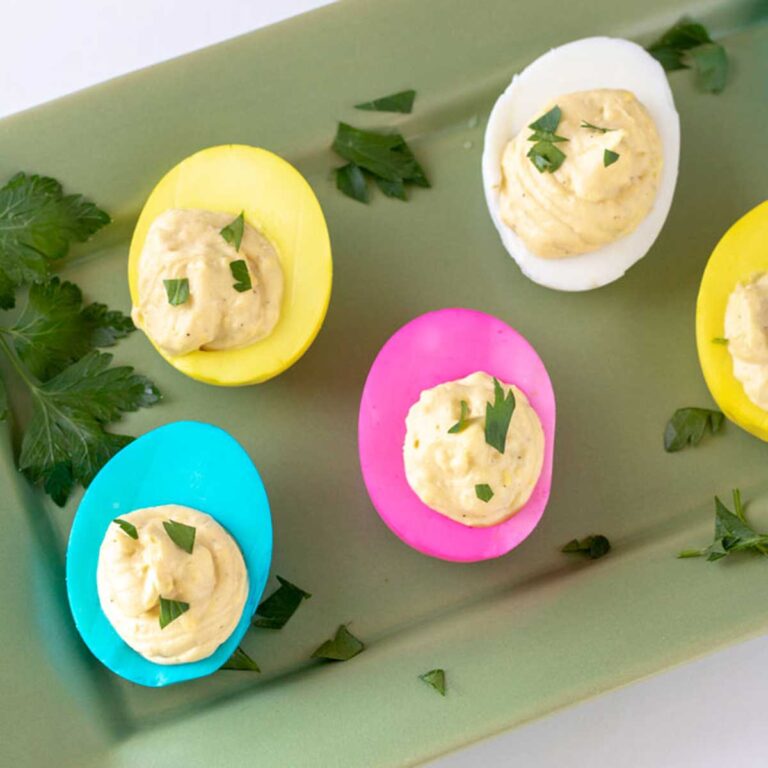 Colorful dyed eggs garnished with parsley for Easter deviled eggs.
