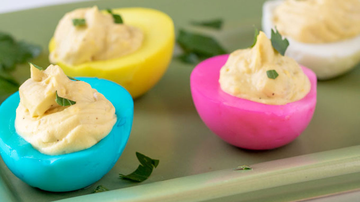 Colorful easter deviled eggs garnished with parsley