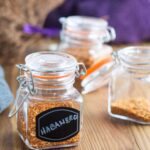 Small spice jars filled with dried habanero flakes.