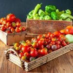 colorful tomatoes and peppers in baskets