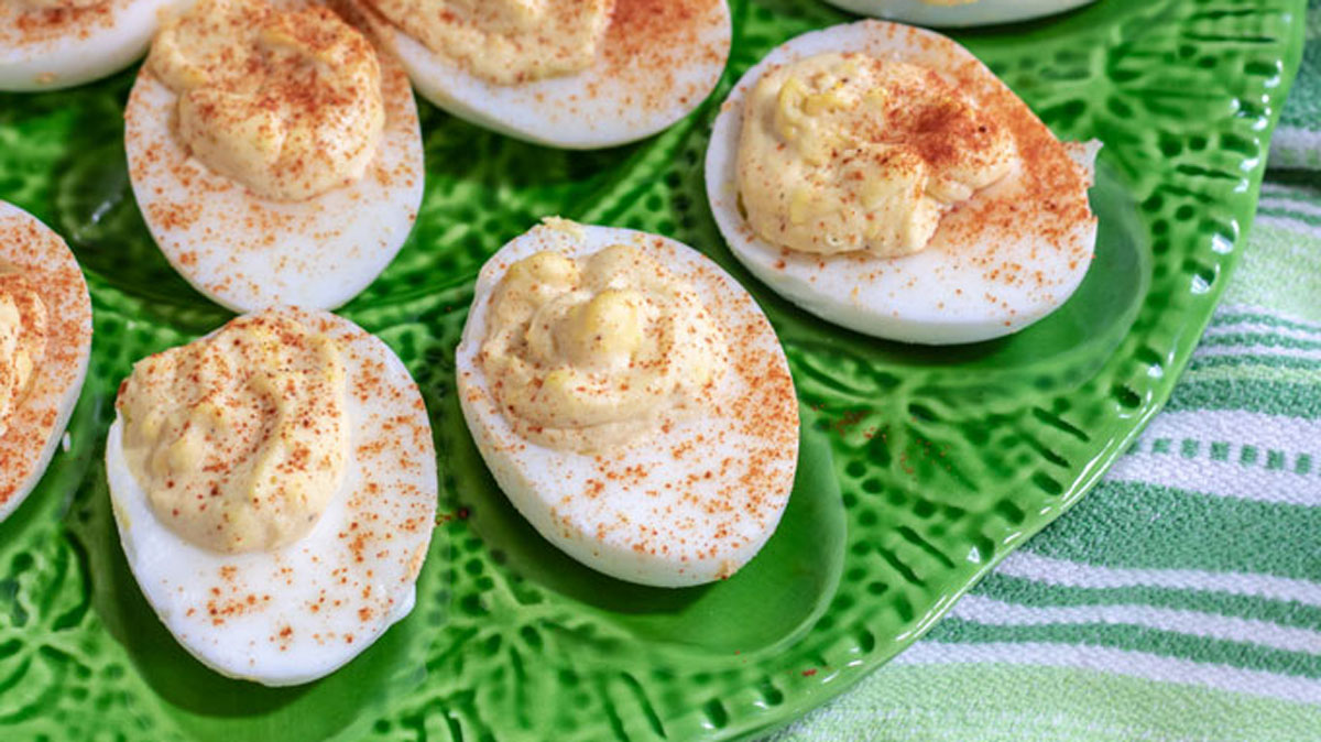Smoky deviled eggs on a platter that is made for them.