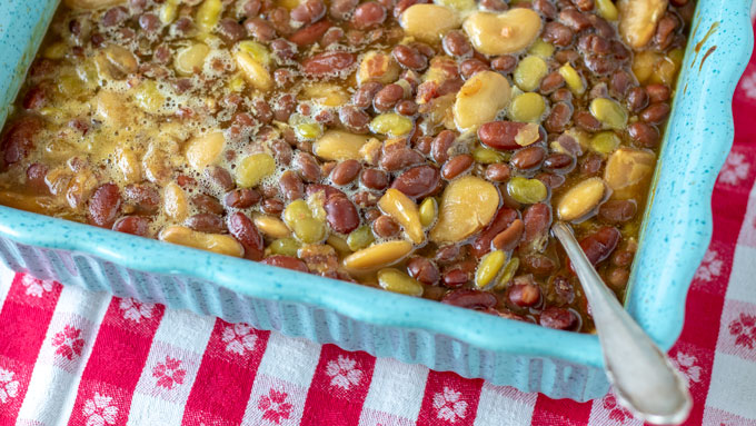 Colorful baked beans in blue casserole