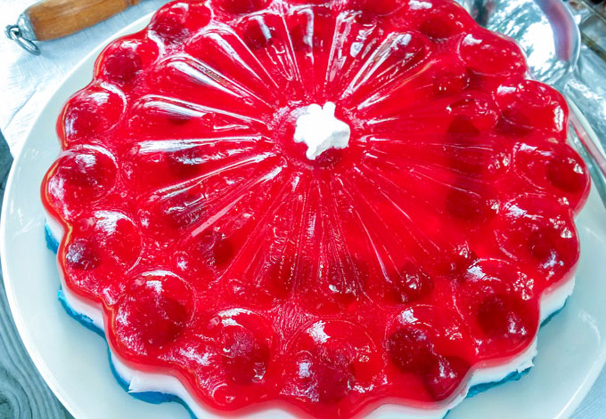 Layered jello mold on a white platter