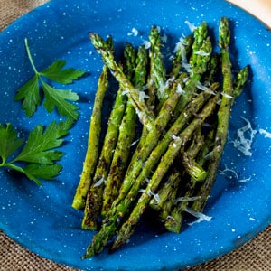 grilled asparagus on blue pewter plate