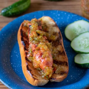 grilled hot dog and bun topped with sweet pickle relish