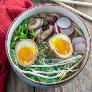 Chicken ramen in bowl with ramen egg and colorful veges.