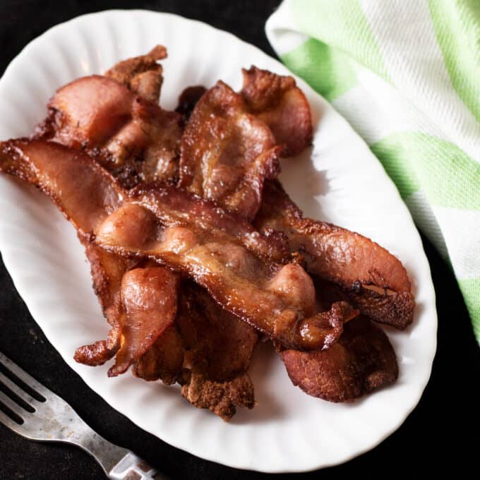 Crispy bacon on white plate.