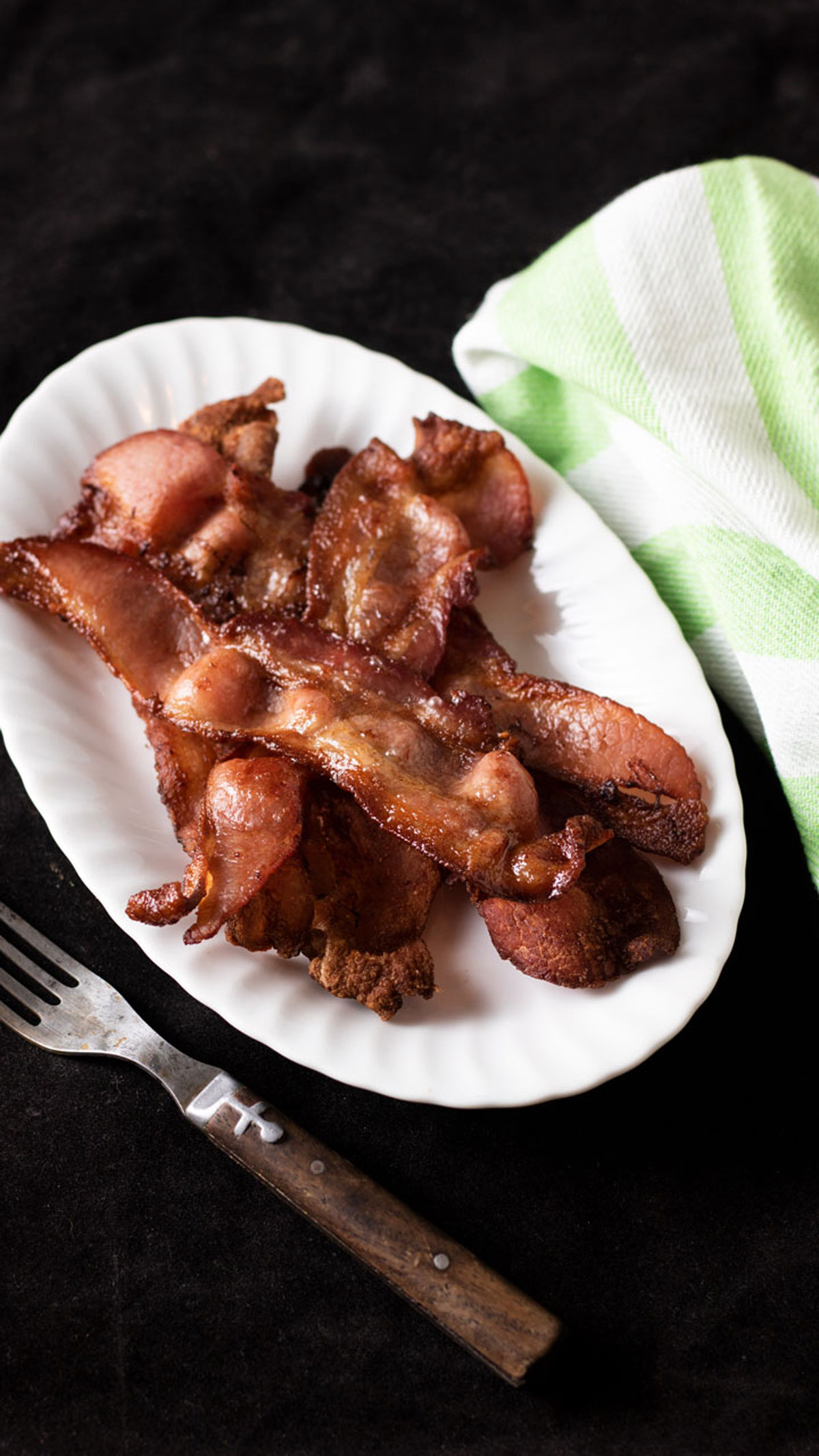 Crispy bacon on white plate.