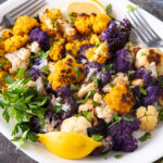 Colorful roasted cauliflower in a white bowl.