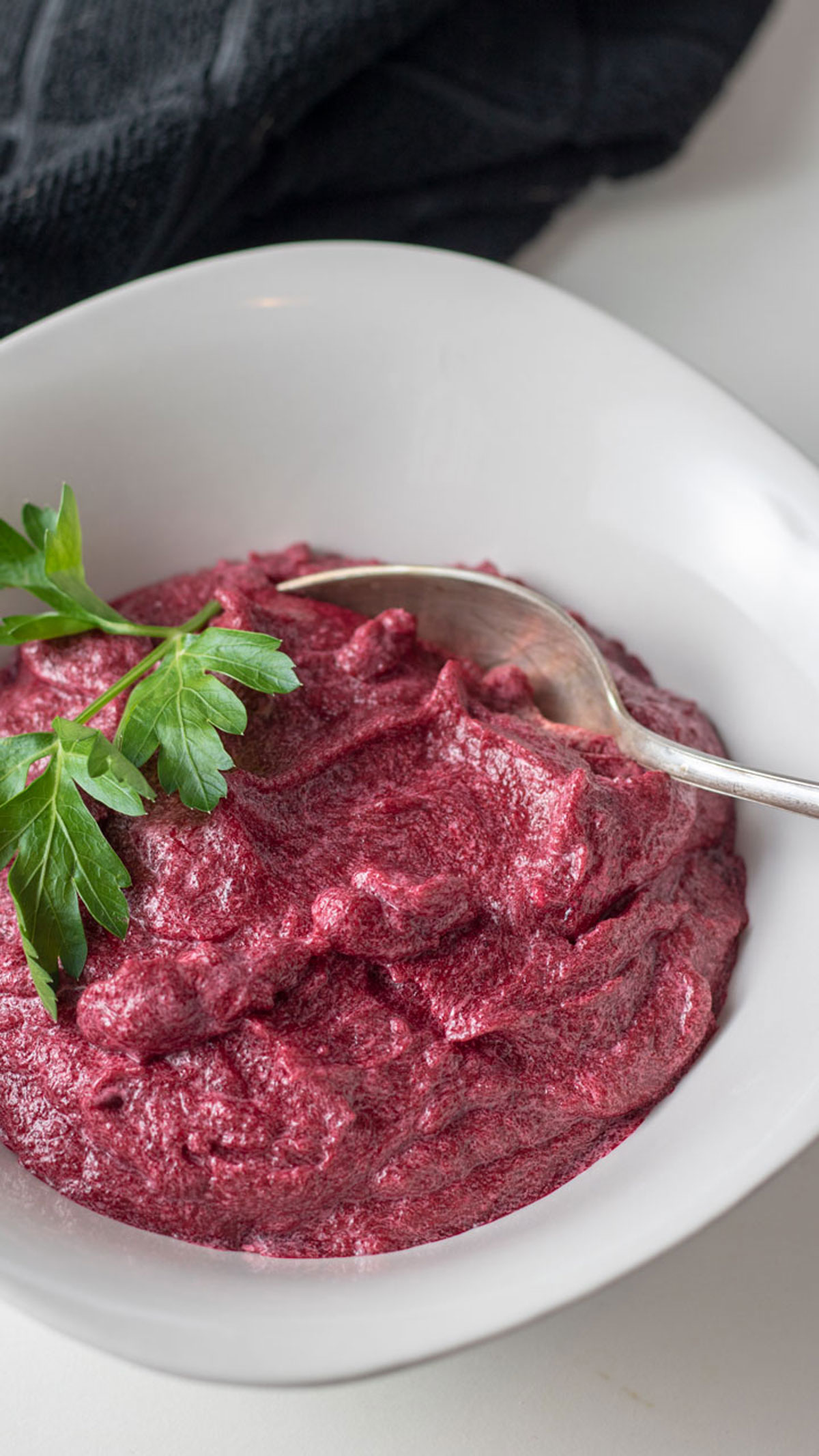 Puree in white bowl with parsley garnish.