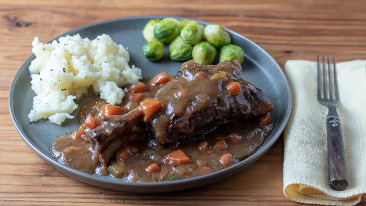 Lamb dinner with potatoes and Brussels sprouts.
