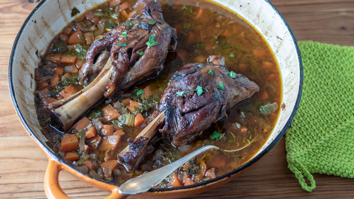 Finished lamb shanks in skillet.