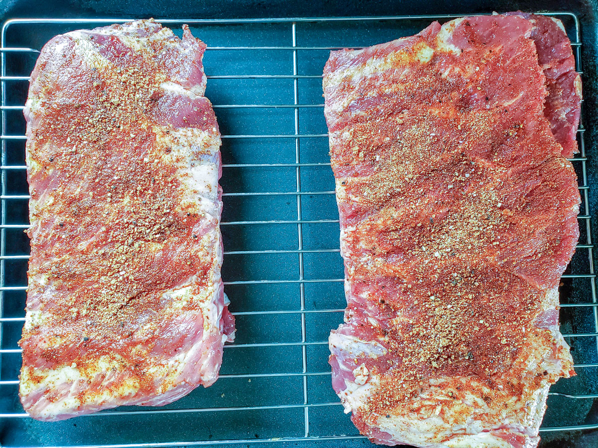 Ribs with dry rub on a wire rack.