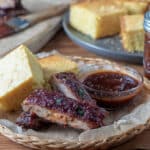 slice ribs with cornbread on wicker basket.