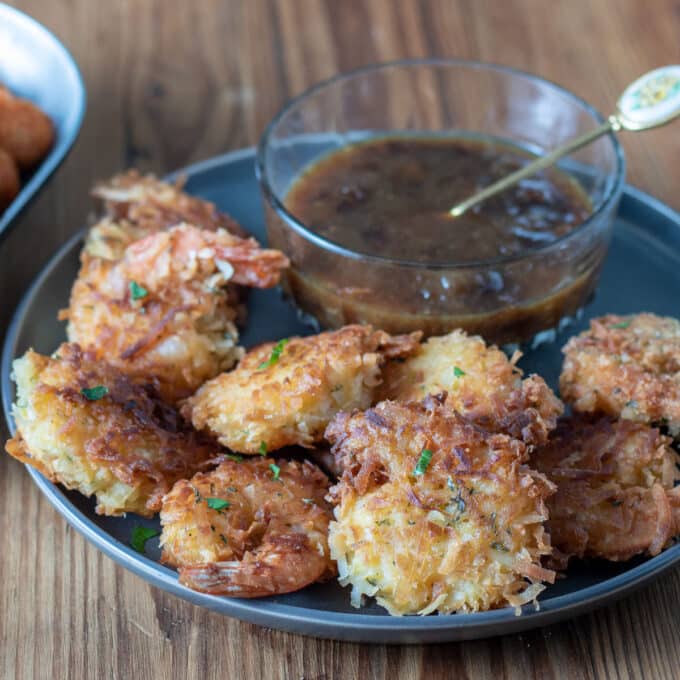 coconut shrimp on gray plate with dipping sauce