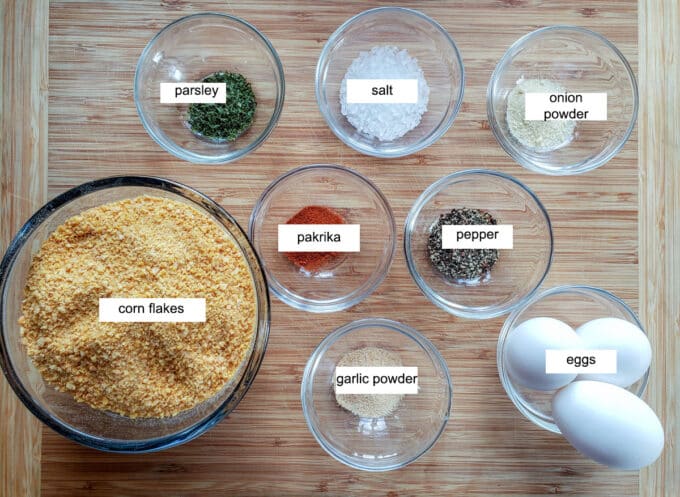 Ingredients for breading- corn flakes, parsley, salt, onion powder, pepper, paprika, garlic powder, eggs.