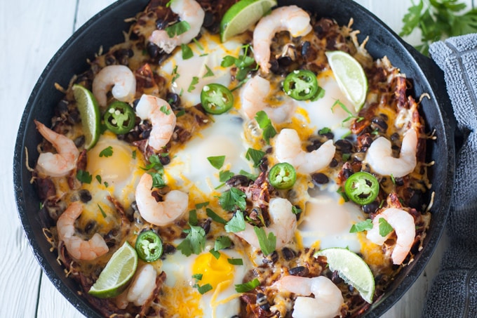 cast iron pan that chilaquiles recipe was baked in with single serving on a plate 