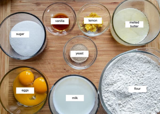 Ingredients for yeast dough sugar, vanilla, lemon, butter, yeast, eggs, milk, flour.