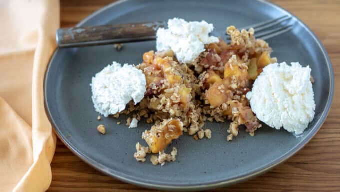 Crisp with ice cream on gray plate.
