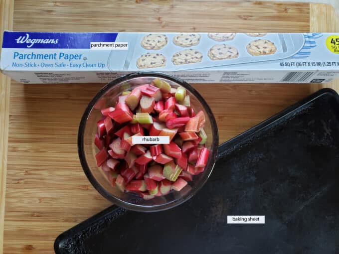 Equipment needed for freezing rhubarb; parchment, rhubarb, baking sheet.