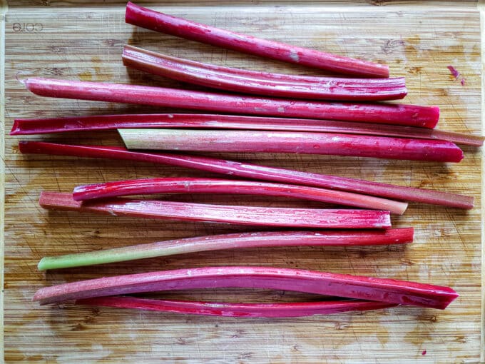 Rhubarb leaf stalks (petioles) on cutting board.