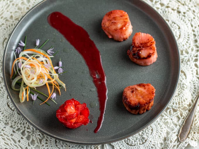 Scallops with strawberry sauce and micro salad.