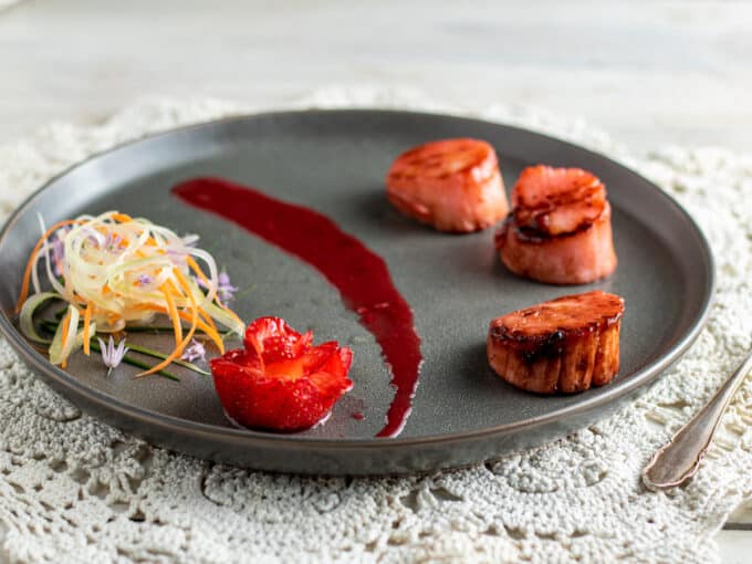 Plate with scallops and strawberry flower.