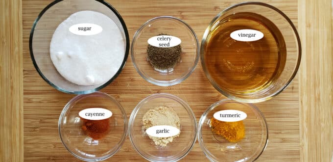 Ingredients for candied jalapenos, sugar celery seed, vinegar, cayenne, garlic, turmeric.