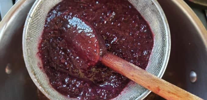 Strain processed cherries through sieve to remove skins.