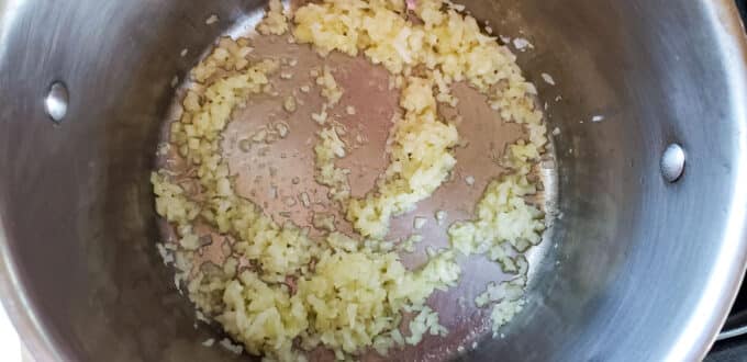 Onion sauteing in a large pot.