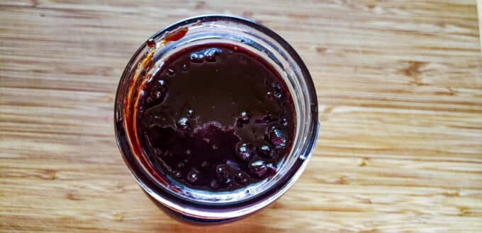 Wiping rims of jars.
