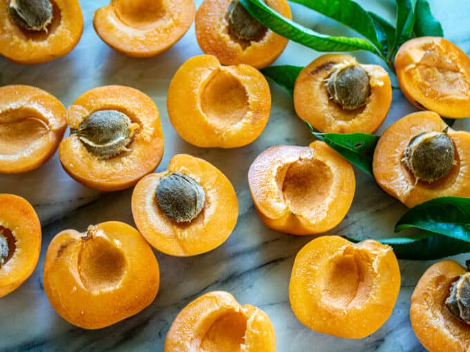 Apricot halves with pits in some.