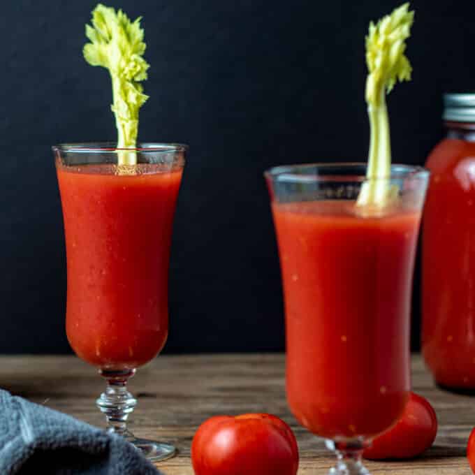 Glasses of tomato juice with celery.