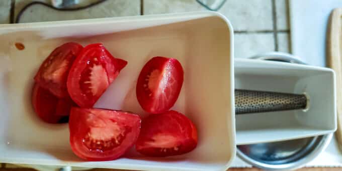 Kitchenaid vegetable strainer with chopped tomatoes loaded.