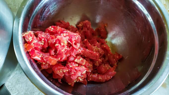 Tomato skins and seeds in bowl.