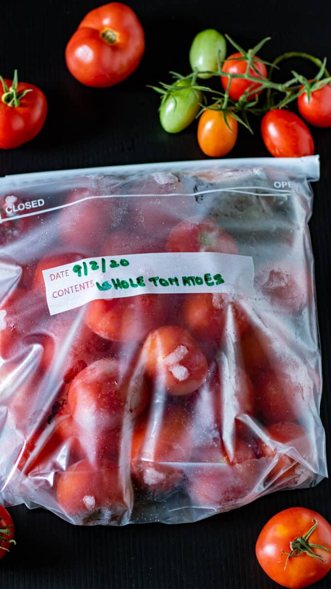 Whole red tomatoes in gallon freezer bags.