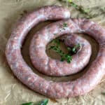 Whirl of venison breakfast sausage on brown paper.