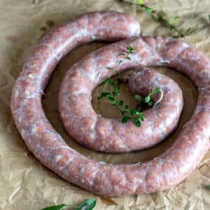 Whirl of venison breakfast sausage on brown paper.