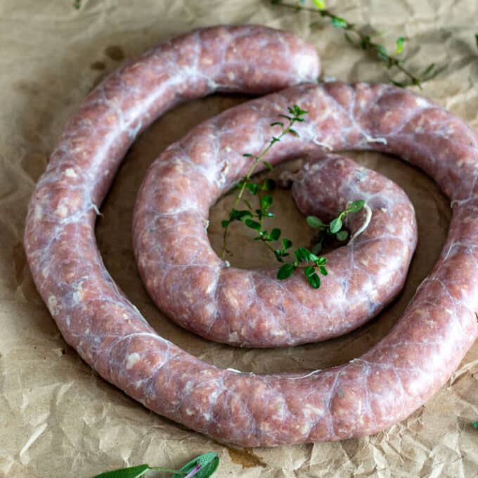 Whirl of venison breakfast sausage on brown paper.