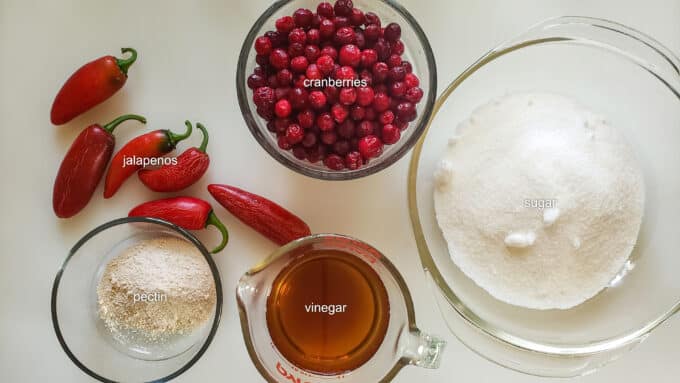 Ingredients needed for recipe; cranberries, jalapenos, sugar, pectin, vinegar.