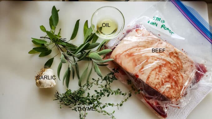 Ingredients for beef strip loin; beef, olive oil, garlic, sage, thyme.